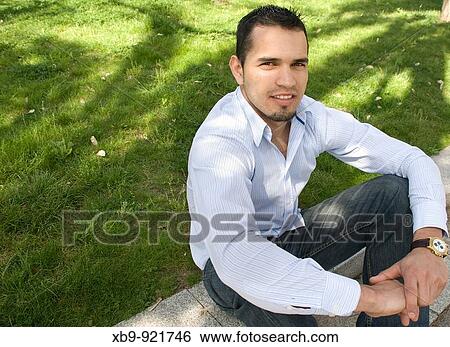 Smiling young Latino man View Large Photo Image Stock Photograph - Smiling young Latino man. Fotosearch