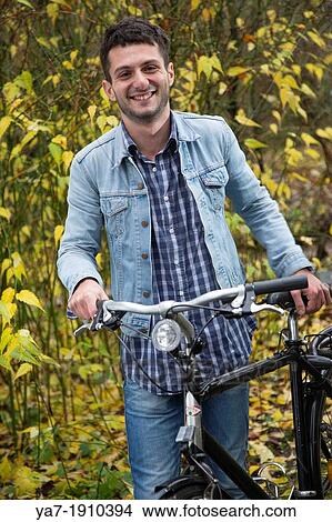 Smiling Young Man With Bike View Large Photo Image Picture - Smiling Young Man With Bike. Fotosearch
