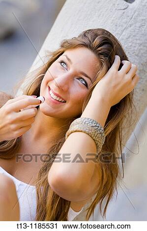 Smiling young woman portrait with a lipstick View Large Photo Image Stock Image - Smiling young woman portrait with a lipstick. Fotosearch