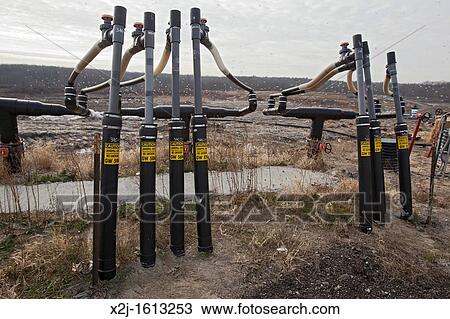 Stock Image - Smith's Creek, Michigan - Wells collect methane gas from decaying garbage at St Clair County's Smith's Creek Landfill. Fotosearch
