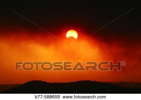 Smoke from bushfires in Ku-ring-gai Chase National Park, north of Sydney allows perfect viewing of a partial eclipse of sun and moon on 4th December 2002. New South Wales. Australia. View Large Photo Image Stock Photo - Smoke from bushfires in Ku-ring-gai Chase National Park, north of Sydney allows perfect viewing of a partial eclipse of sun and moon on 4th December 2002. New South Wales. Australia.. Fotosearch