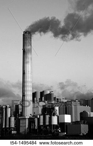 Picture - Smoke rises from the chimney of a factory. Fotosearch