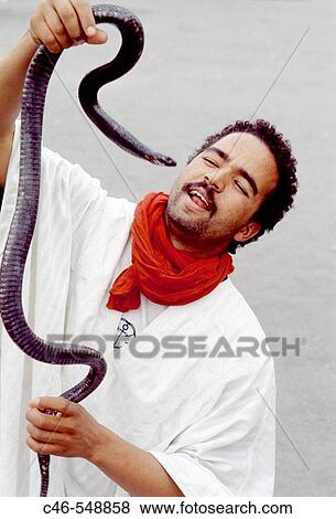 Snake charmer on Jemaa El-Fna square, the liveliest place night and day in Marrakech. Morocco View Large Photo Image Stock Photo - Snake charmer on Jemaa El-Fna square, the liveliest place night and day in Marrakech. Morocco. Fotosearch