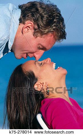 Picture - sneaking up for a kiss. Fotosearch