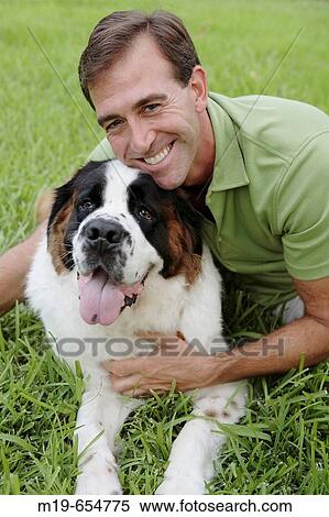 Sniling man with his dog View Large Photo Image Stock Photography - Sniling man with his dog. Fotosearch