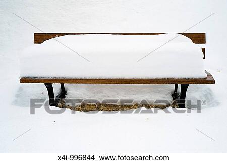 Picture - Snow-covered bench in a public park. Fotosearch