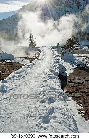 Stock Image - Snow Covered Boardwalk, Black Sand Basin, Winter, Yellowstone NP, WY. Fotosearch