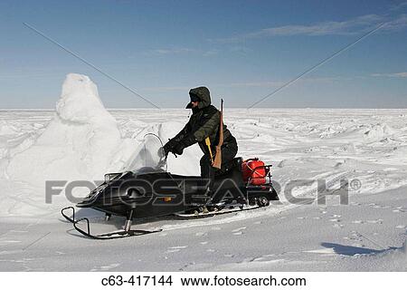 Snow machine on frozen sea ice of Hudson Bay in late winter. Churchill, Manitoba, Canada. View Large Photo Image Picture - Snow machine on frozen sea ice of Hudson Bay in late winter. Churchill, Manitoba, Canada.. Fotosearch
