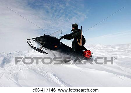 Snow machine on frozen sea ice of Hudson Bay in late winter. Churchill, Manitoba, Canada. View Large Photo Image Stock Photograph - Snow machine on frozen sea ice of Hudson Bay in late winter. Churchill, Manitoba, Canada.. Fotosearch