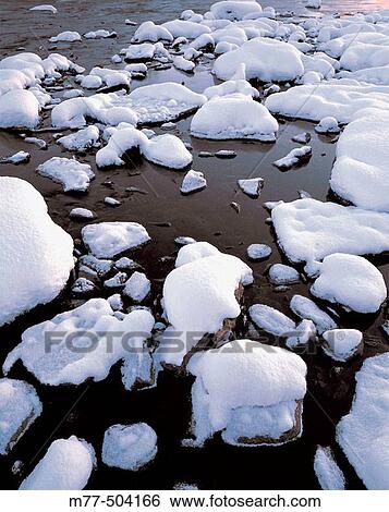 Snow on stones in river. Vindel? lven. V? sterbotten. Sweden View Large Photo Image Stock Photograph - Snow on stones in river. Vindel? lven. V? sterbotten. Sweden. Fotosearch