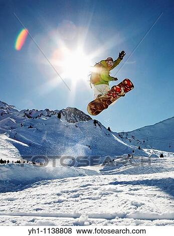 Snowboarder jumping right in View Large Photo Image Stock Photo - Snowboarder jumping right in. Fotosearch