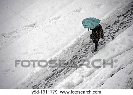 snowed street, man walking under umbrella, snowfall, winter in Geneve, Switzerland View Large Photo Image Stock Photo - snowed street, man walking under umbrella, snowfall, winter in Geneve, Switzerland. Fotosearch