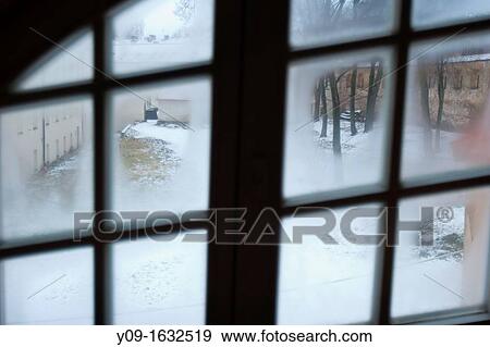 Stock Photo - Snowy Garden From the window, Vilnius, Lithuania. Fotosearch