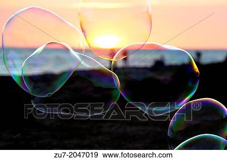 Stock Photo - Soap bubbles in front of the sunset in Sant Antoni de Portmany, Ibiza.. Fotosearch