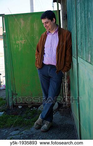 Sofia, Bulgaria. Man leaning aginst a wall in the Sofian ghetto Hristo Botev. View Large Photo Image Stock Image - Sofia, Bulgaria. Man leaning aginst a wall in the Sofian ghetto Hristo Botev.. Fotosearch