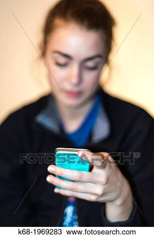Soft focus of a girl, 17, using a smart phone View Large Photo Image Stock Image - Soft focus of a girl, 17, using a smart phone. Fotosearch