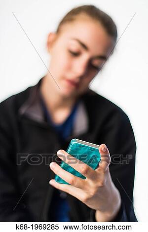 Soft focus of a girl, 17, using a smart phone View Large Photo Image Stock Photography - Soft focus of a girl, 17, using a smart phone. Fotosearch