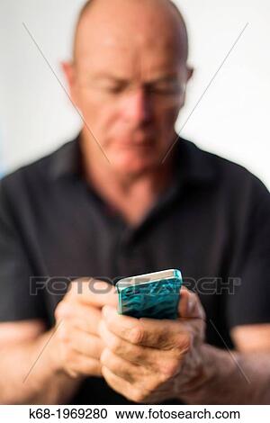 Soft focus on a smart phone, used by a middle-aged man View Large Photo Image Stock Image - Soft focus on a smart phone, used by a middle-aged man. Fotosearch