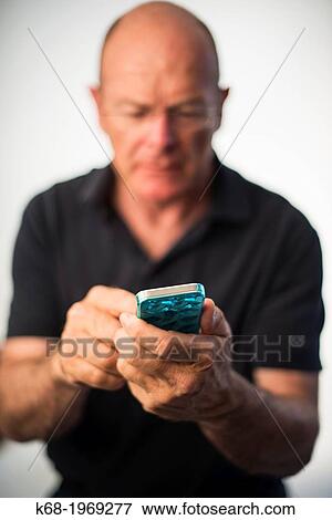 Soft focus on a smart phone, used by a middle-aged man View Large Photo Image Stock Photo - Soft focus on a smart phone, used by a middle-aged man. Fotosearch