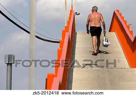 Stock Photo - Solitary walk across the footbridge Pinedo, Valencia.. Fotosearch