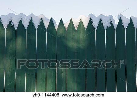 Some snow on a green fence View Large Photo Image Stock Photo - Some snow on a green fence. Fotosearch