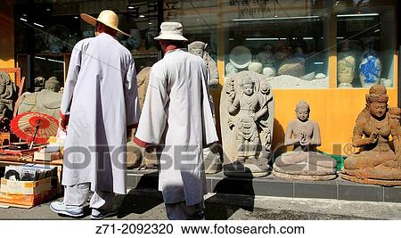Stock Image - South Korea, Seoul, Insa-dong, monks shopping for Buddhas,.. Fotosearch