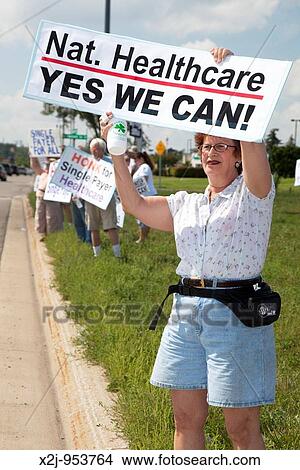 Southfield, Michigan - People hold signs along a busy highway supporting national health care reform, and especially supporting a single-payer plan View Large Photo Image Picture - Southfield, Michigan - People hold signs along a busy highway supporting national health care reform, and especially supporting a single-payer plan. Fotosearch
