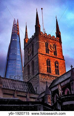 Stock Photography - Southwark Cathedral from the late Middle Ages, and The Shard, Europe's tallest office building, in the heart of London, England, on a Winter evening of disturbed light. Fotosearch