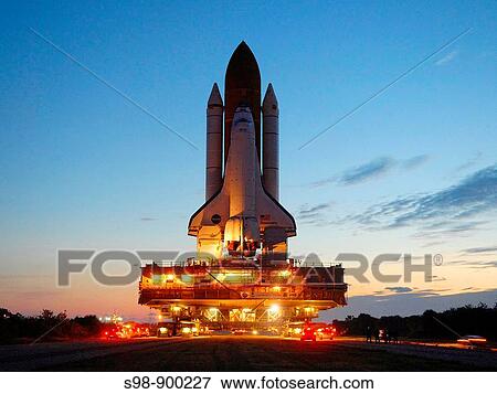 Space shuttle Discovery is silhouetted against the dawn's early light as it makes the slow 3 4-mile journey to Launch Pad 39A at NASA? s Kennedy Space Center in Florida View Large Photo Image Stock Photo - Space shuttle Discovery is silhouetted against the dawn's early light as it makes the slow 3 4-mile journey to Launch Pad 39A at NASA? s Kennedy Space Center in Florida. Fotosearch