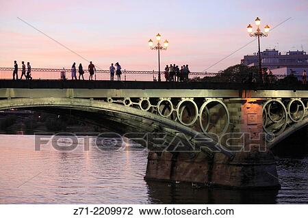 Spain, Andalusia, Seville, Isabel II Bridge, Guadalquivir River, people,. View Large Photo Image Stock Image - Spain, Andalusia, Seville, Isabel II Bridge, Guadalquivir River, people,.. Fotosearch
