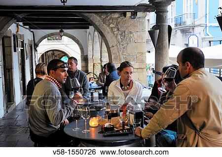 Stock Photograph - Spain, Asturias, Aviles, Calle Galiana by night, Wine bar.. Fotosearch