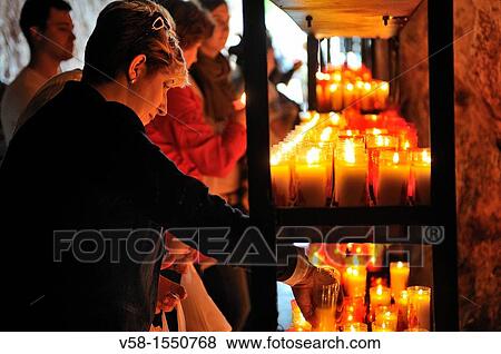 Stock Photo - Spain, Asturias, Picos de Europa National Park, Covadonga, Pilgrims lighting candles near the shrine of the virgin Mary. Fotosearch