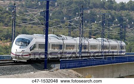 Spain, Catalonia, Lleida province, High Speed Train, AVE Serie 103 passing by the Vinaixa viaduct View Large Photo Image Stock Photo - Spain, Catalonia, Lleida province, High Speed Train, AVE Serie 103 passing by the Vinaixa viaduct. Fotosearch