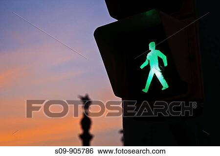 Spain, Cataluna, Barcelona, La Barceloneta, Green man crossing traffic signal and Monument a Colom in the background at sunset View Large Photo Image Stock Photograph - Spain, Cataluna, Barcelona, La Barceloneta, Green man crossing traffic signal and Monument a Colom in the background at sunset. Fotosearch