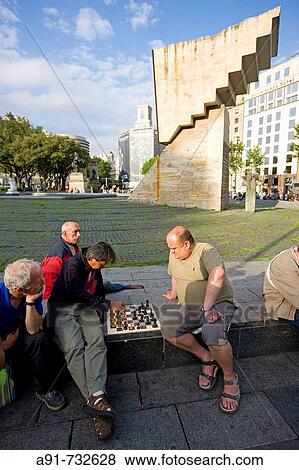 Spain, Catalunya, Barcelona, Pla? a de Catalunya, playing chess, monument to Francesc Maci? by Josep Maria Subirachs in background View Large Photo Image Stock Photo - Spain, Catalunya, Barcelona, Pla? a de Catalunya, playing chess, monument to Francesc Maci? by Josep Maria Subirachs in background. Fotosearch