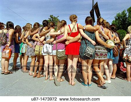 Stock Image - Spain, Madrid, Group of Girls Posing for Photograph. Fotosearch