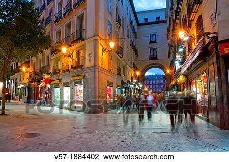 Spain, Madrid, People walking on Postas street at dusk View Large Photo Image Stock Image - Spain, Madrid, People walking on Postas street at dusk. Fotosearch