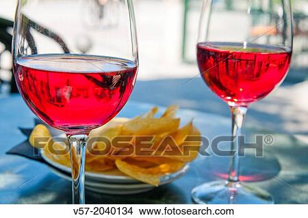 Spanish aperitif: two glasses of rose wine and chips on a terrace. Madrid, Spain. View Large Photo Image Picture - Spanish aperitif: two glasses of rose wine and chips on a terrace. Madrid, Spain.. Fotosearch