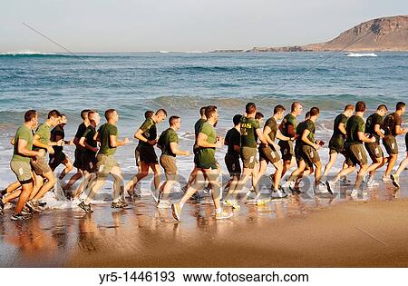 Stock Image - Spanish soldiers running on Las Canteras beach in Las Palmas, Gran Canaria, Canary Islands. Fotosearch
