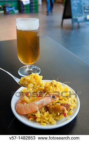 Spanish tapa: paella valenciana and glass of beer. Madrid, Spain. View Large Photo Image Stock Image - Spanish tapa: paella valenciana and glass of beer. Madrid, Spain.. Fotosearch
