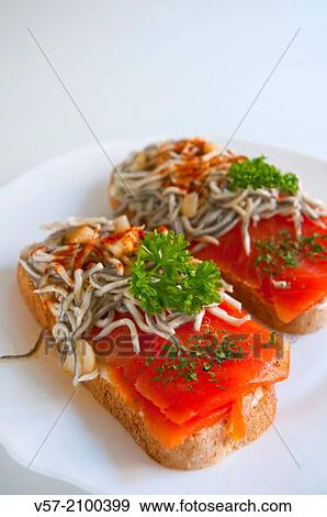 Spanish tapa: toast with smoked salmon and eels. Close view. View Large Photo Image Stock Photo - Spanish tapa: toast with smoked salmon and eels. Close view.. Fotosearch