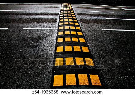 Speed bump on road, Vallecas, Madrid, Spain View Large Photo Image Stock Photo - Speed bump on road, Vallecas, Madrid, Spain. Fotosearch