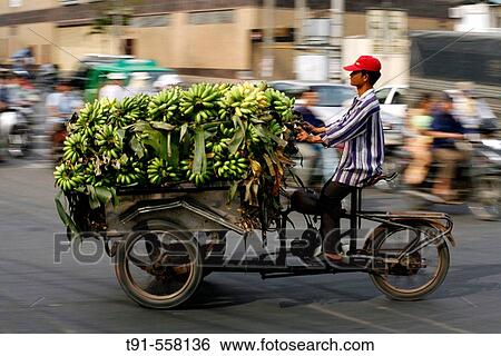 Stock Photograph - Speeding vietnamese moto rickshaws with Bananas. Saigon, Vietnam.. Fotosearch