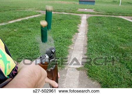 Spent shells eject from the barrels of an over-under double shotgun View Large Photo Image Stock Image - Spent shells eject from the barrels of an over-under double shotgun. Fotosearch
