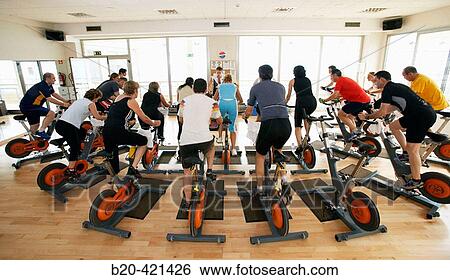 Stock Photograph - Spinning, training program for cardiovascular work and toning up in exercise bicycle. Real Club de Tenis de San SebastiBn, Gipuzkoa, Euskadi.. Fotosearch