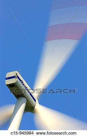 Spinning Wind turbine generator against blue sky View Large Photo Image Picture - Spinning Wind turbine generator against blue sky. Fotosearch