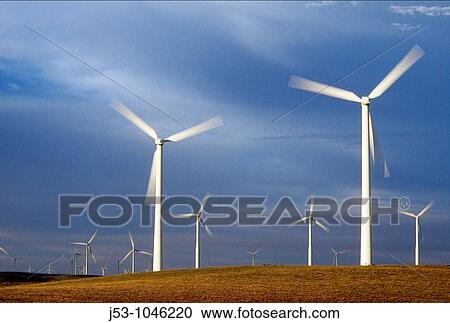 Stock Image - Spinning wind turbines at dusk, Rio Vista, California USA. Fotosearch