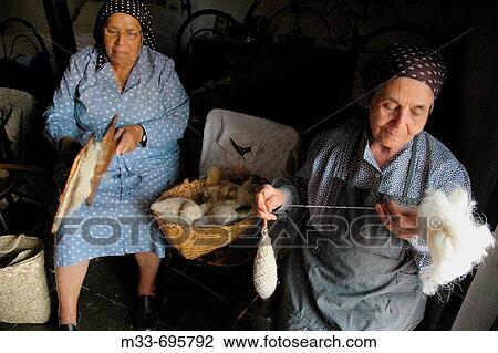 Stock Image - Spinning wool in the Museo Viviente de Viejas Tradiciones, San NicolBs de Tolentino. Gran Canaria, Canary Islands, Spain. Fotosearch