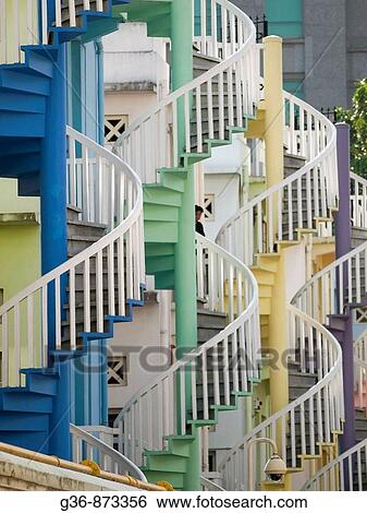 Spiral staircases as exit ways in the back of houses in the city_state of Singapore View Large Photo Image Stock Photograph - Spiral staircases as exit ways in the back of houses in the city_state of Singapore. Fotosearch