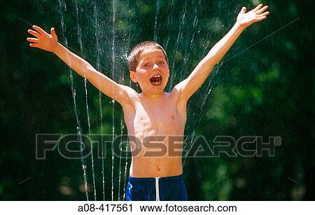 Spirited boy gets wet from sprinkler on a hot summer day. Pennsylvania, USA View Large Photo Image Stock Image - Spirited boy gets wet from sprinkler on a hot summer day. Pennsylvania, USA. Fotosearch